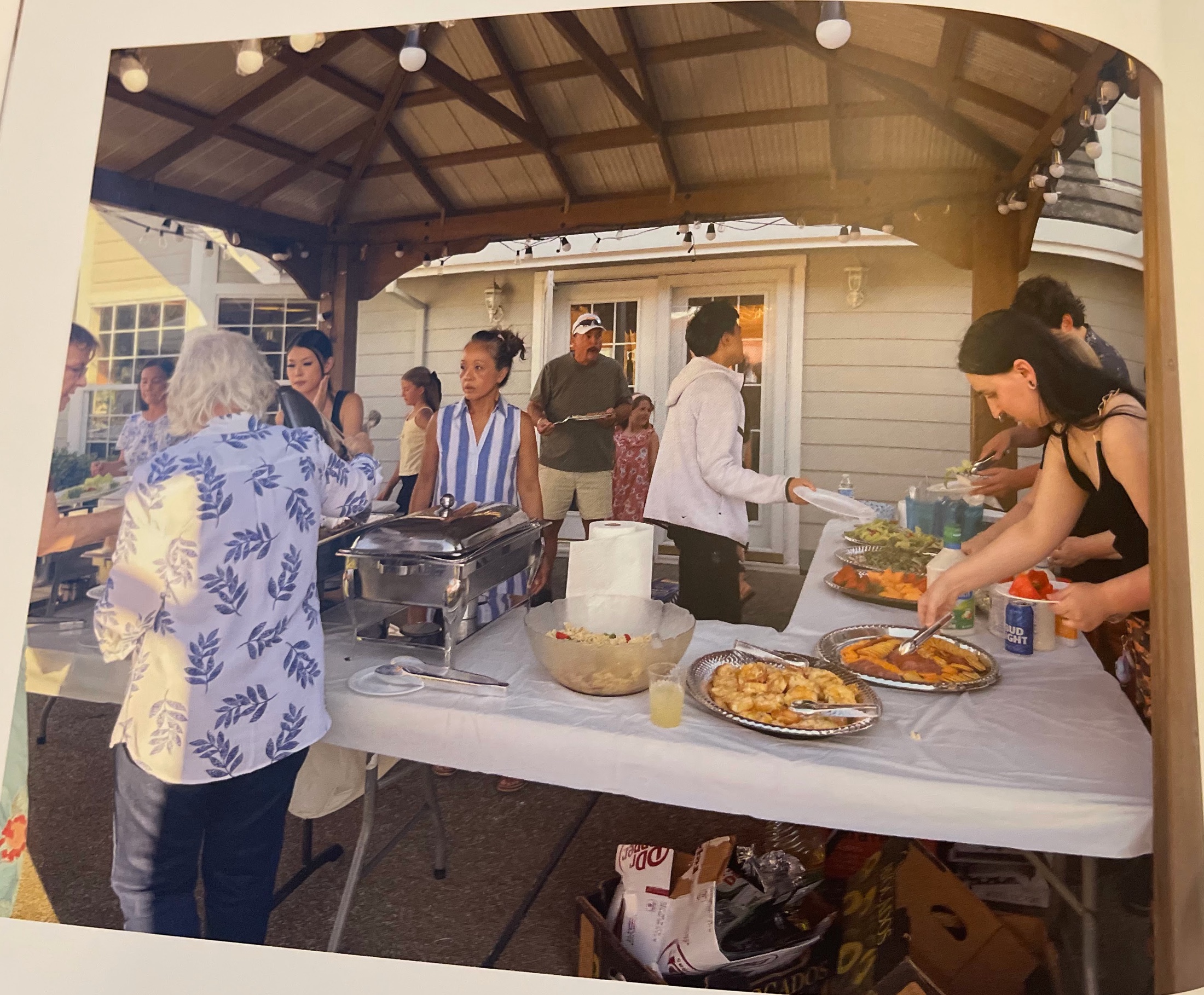 Guests enjoying a catered buffet beside the ranch house