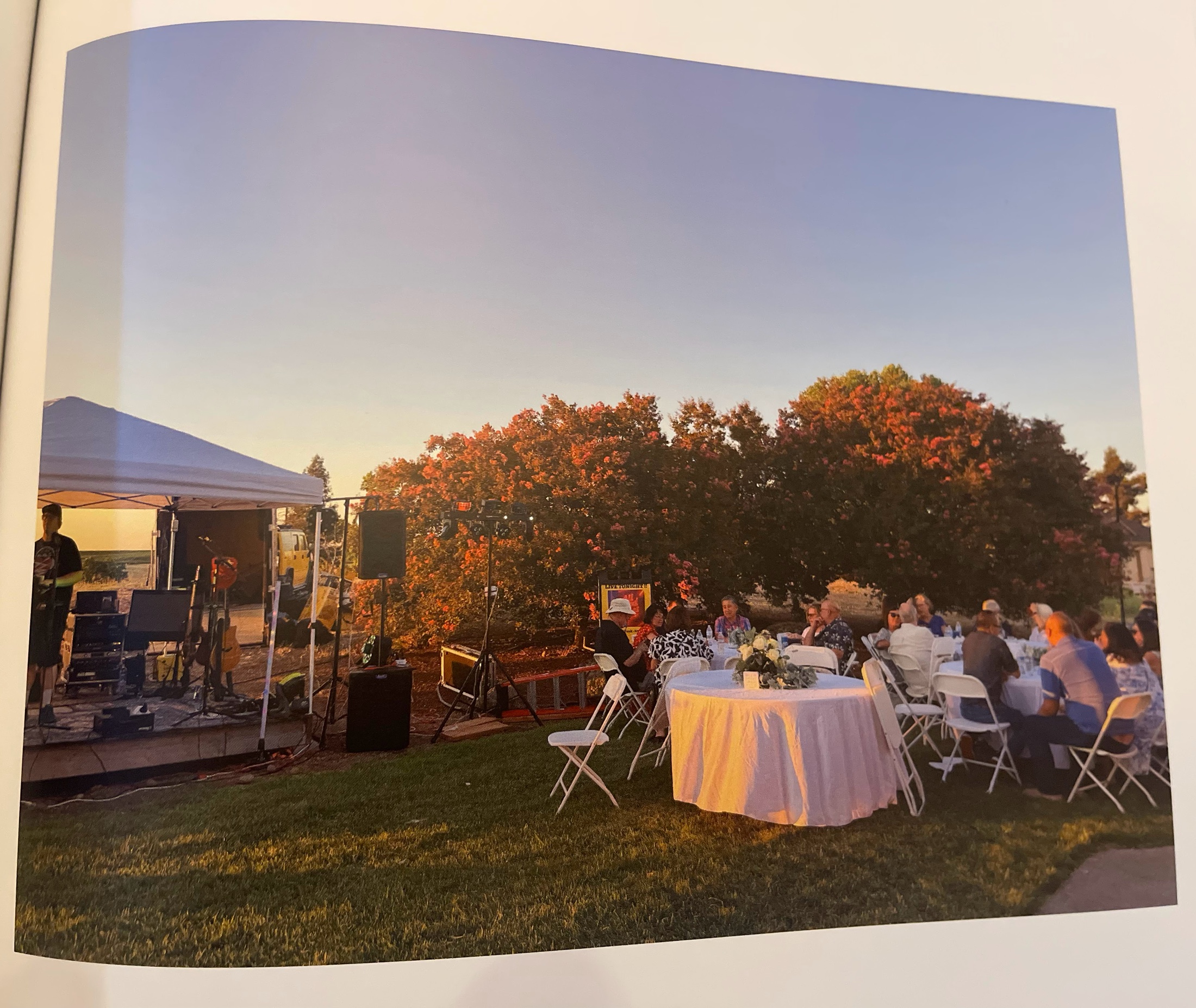 Round reception tables beside the Amber Ranch stage at sunset