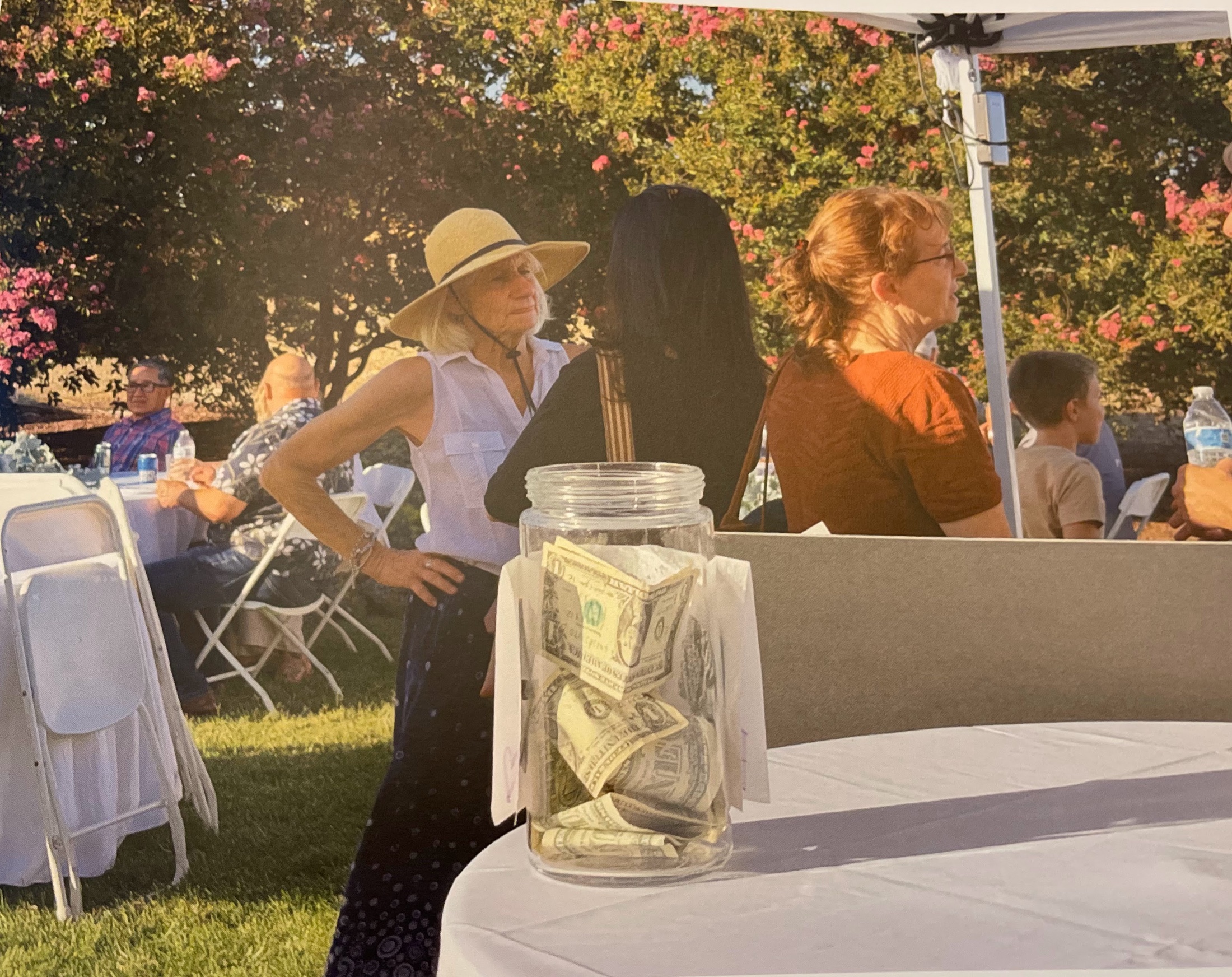 Guests talking near the lawn tables and stage